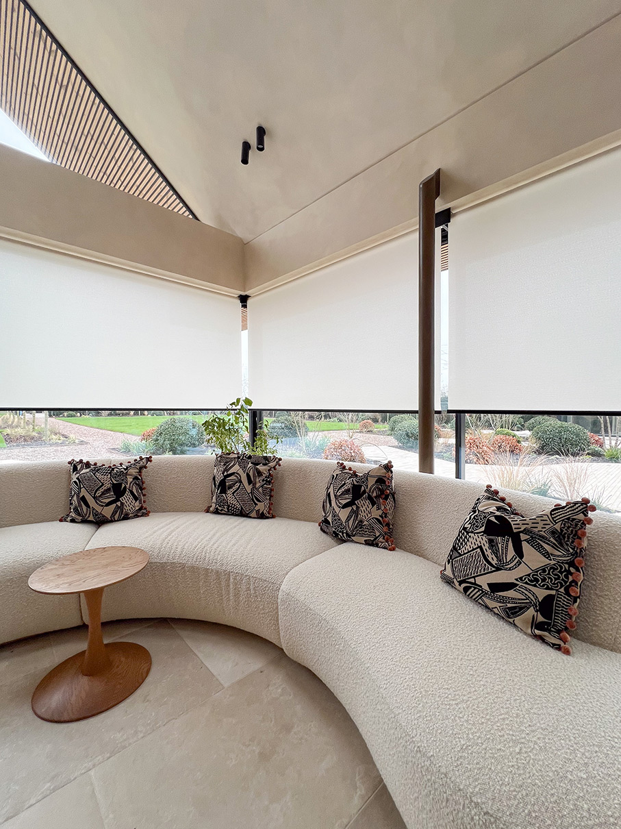Elegant blinds installed to multiple large maxlight sliding doors overlooking garden