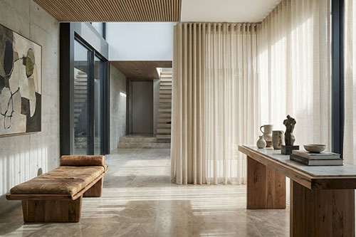 interior Floor-to-ceiling sheer curtains designed as part of a contemporary architectural interior